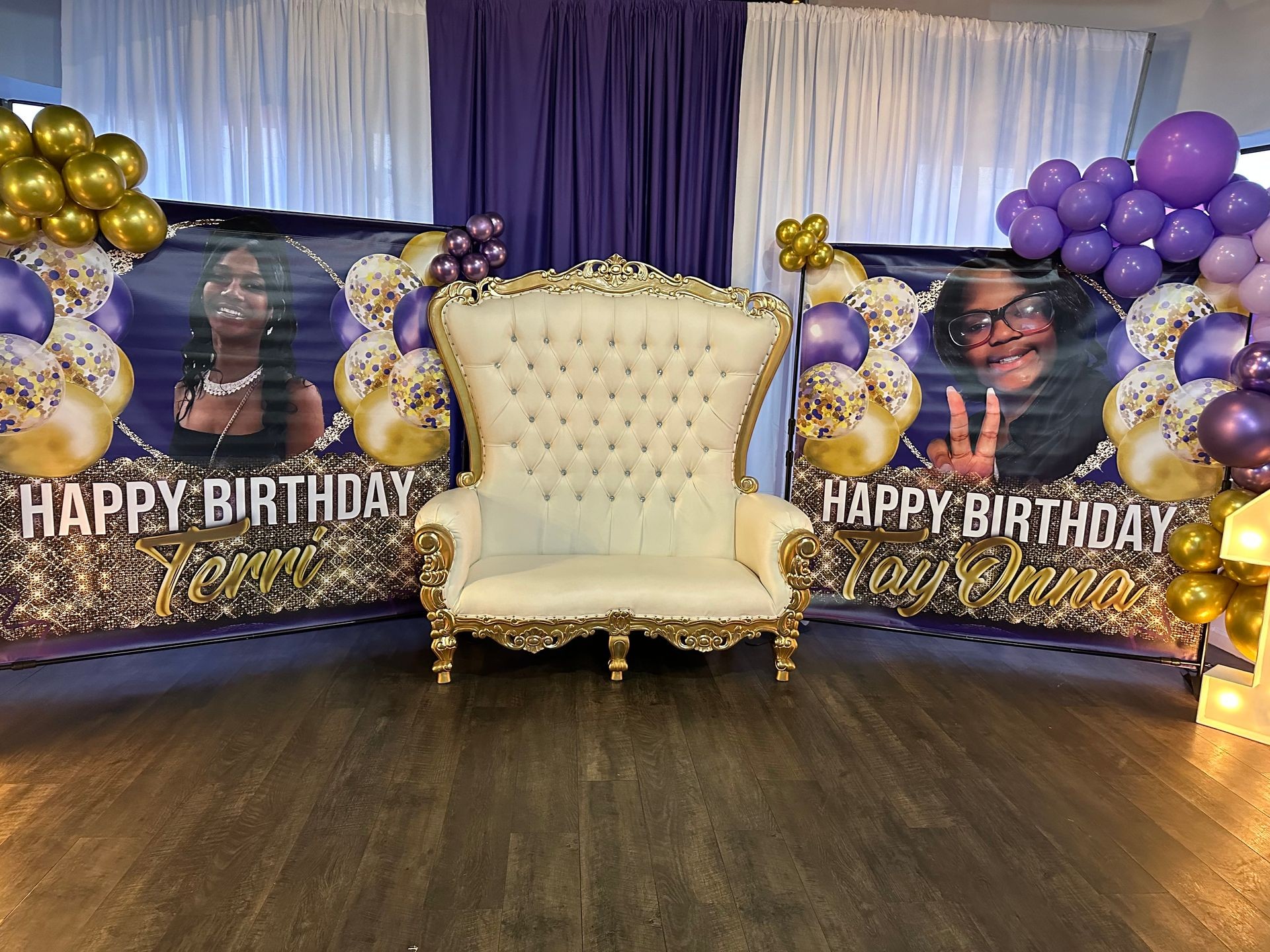 Birthday party setup with decorated chair and banners, balloons on either side.